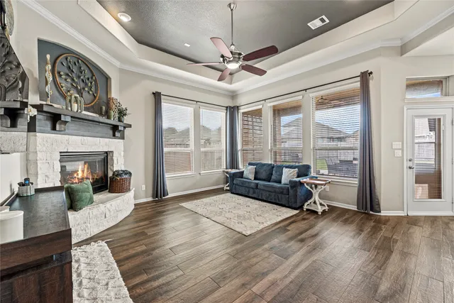 a living room with furniture large window and flat screen tv