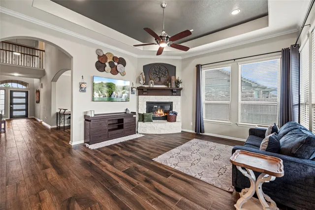a living room with furniture a fireplace and a flat screen tv