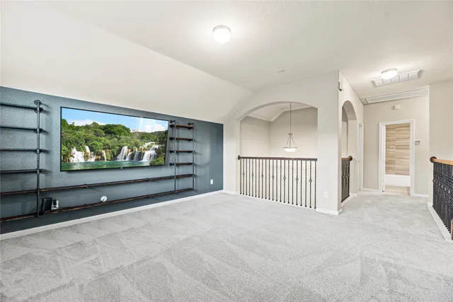 a view of a hallway with a flat screen tv