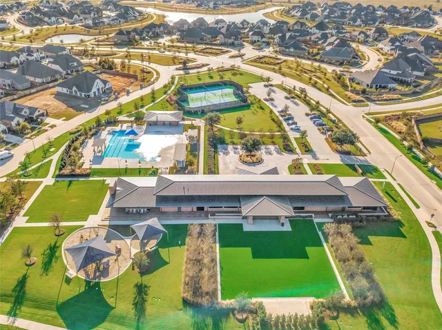 an aerial view of a house with a big yard