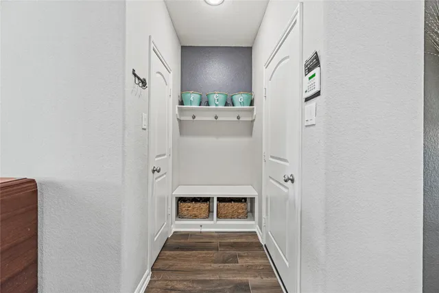 a view of a hallway with wooden floor and staircase