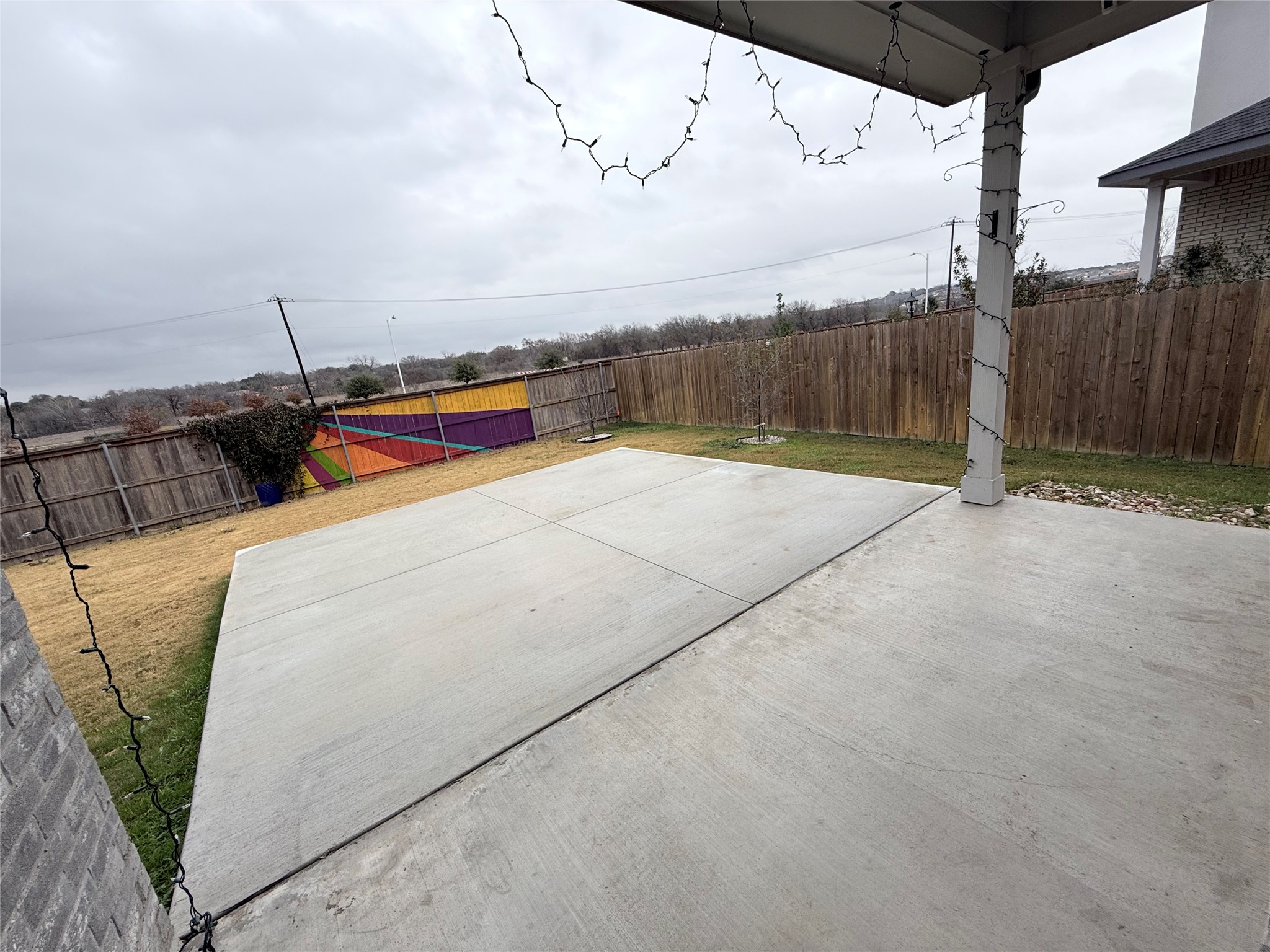 4516 Sea Salt Drive Austin, TX 78747 - Photo 12 of 14 The backyard has a covered patio with extended concrete pad ~ This yard is private with no house behind