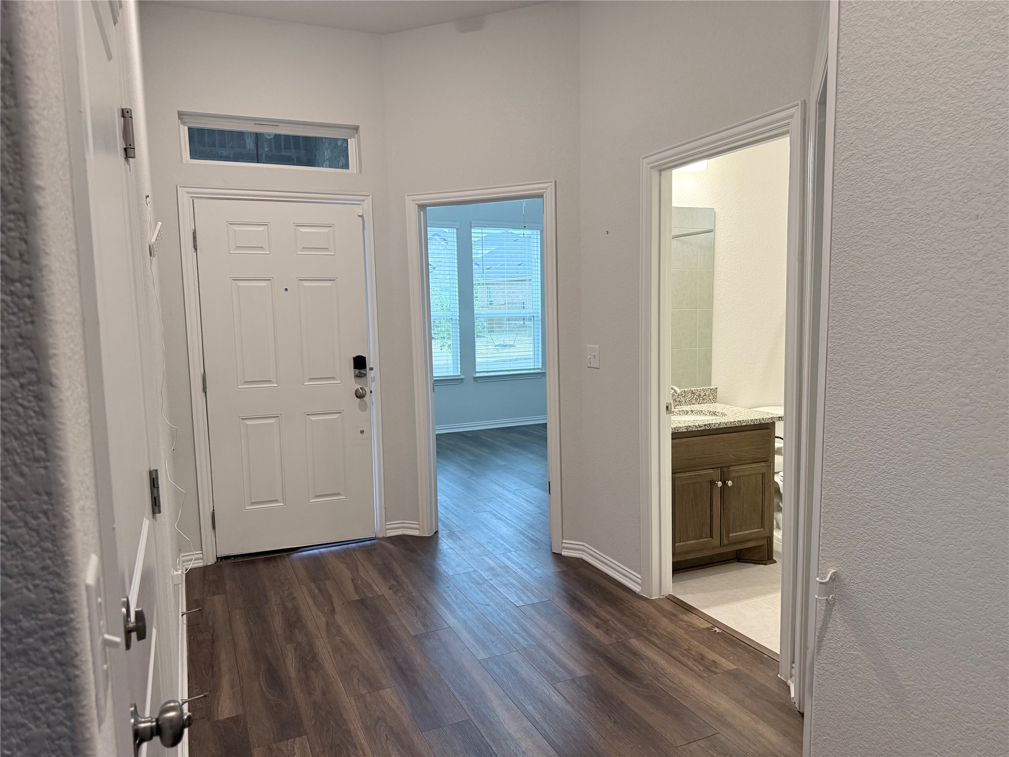 4516 Sea Salt Drive Austin, TX 78747 - Photo 2 of 14 The foyer features hight ceilings and beautiful laminate flooring - there is no carpet in this home