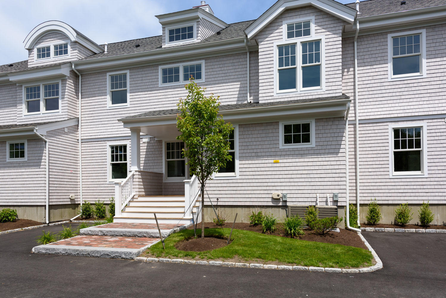 780 Craigville Beach Road, Unit F2 Centerville, MA 02632 - Photo 2 of 13 a front view of a house with a yard