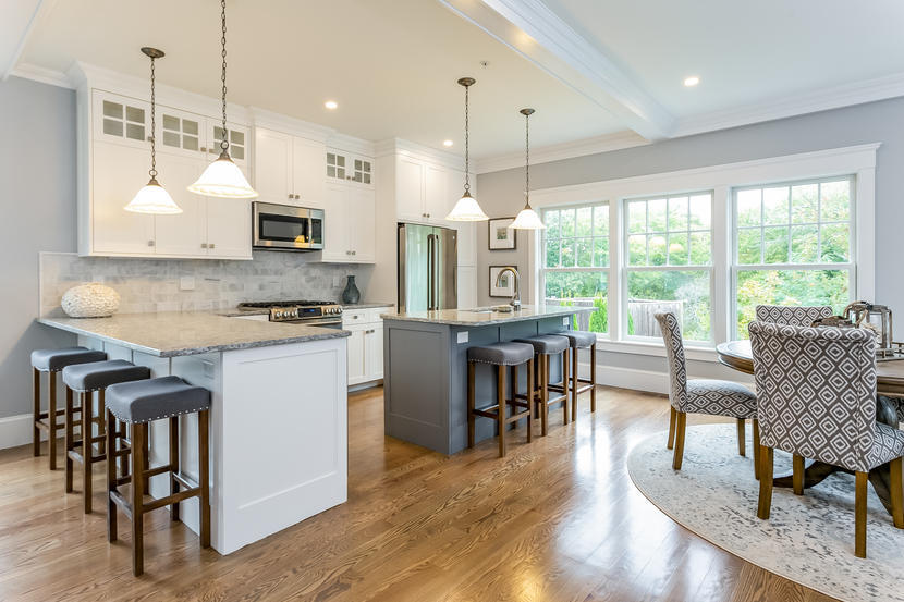 780 Craigville Beach Road, Unit F2 Centerville, MA 02632 - Photo 3 of 13 a kitchen with stainless steel appliances granite countertop a stove a refrigerator a kitchen island a dining table and chairs with wooden floor