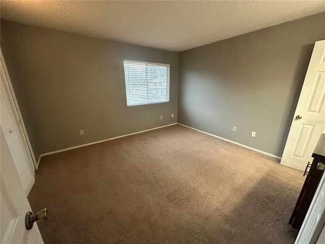 a view of an empty room with a fireplace