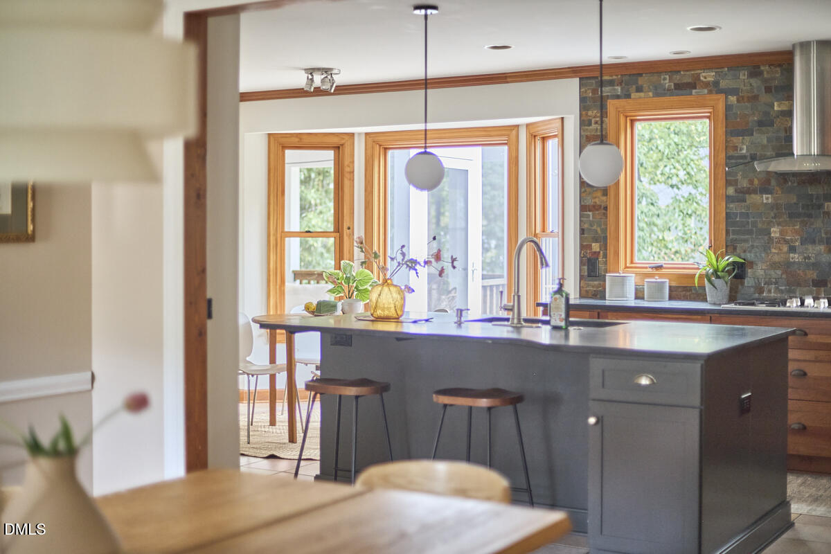 8109 Olde Hill Court Raleigh, NC 27615 - Photo 14 of 65 a kitchen with a sink a window and chairs