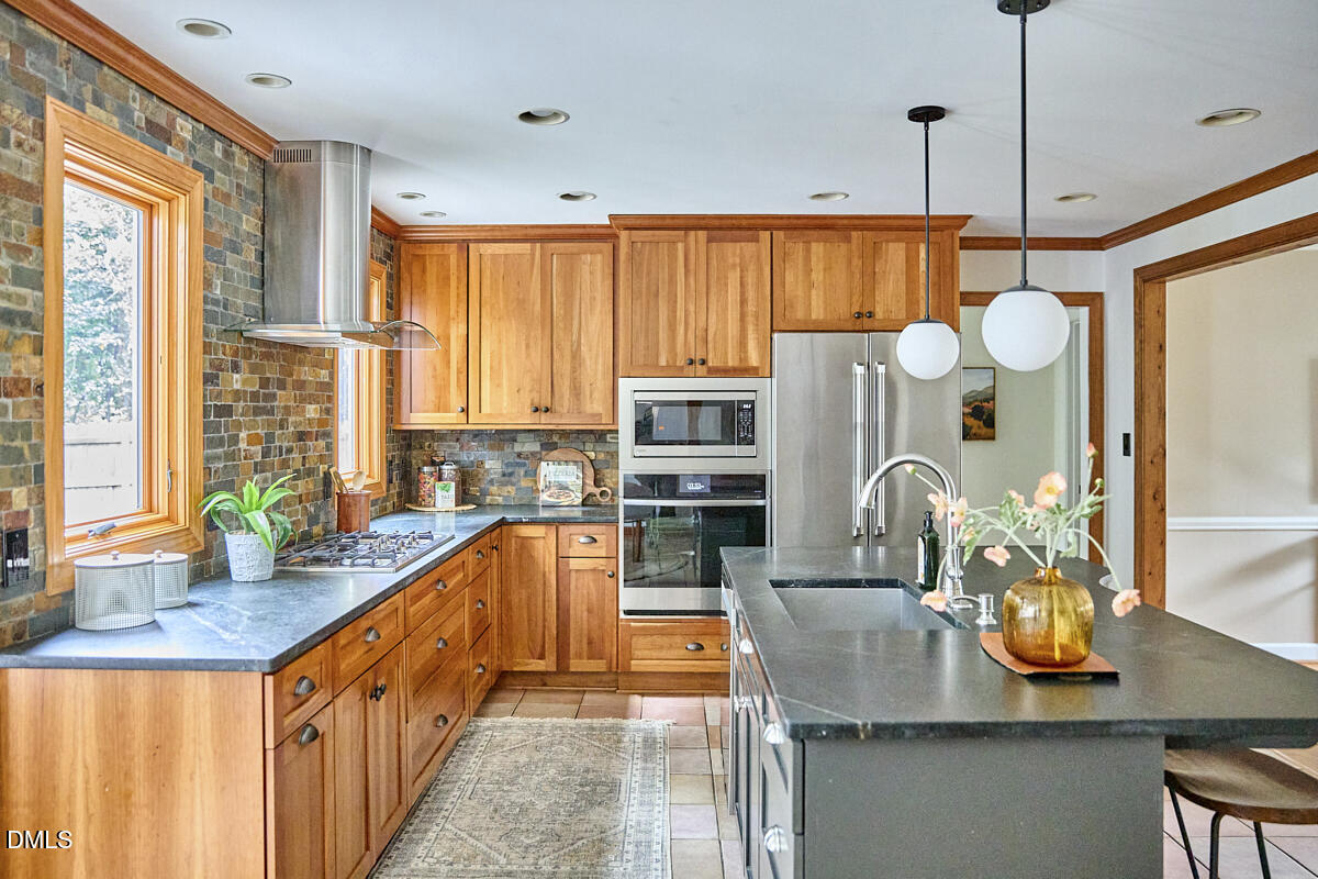 8109 Olde Hill Court Raleigh, NC 27615 - Photo 18 of 65 a kitchen with stainless steel appliances granite countertop a sink a stove and a wooden floors
