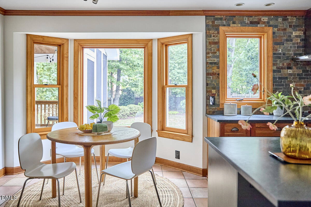 8109 Olde Hill Court Raleigh, NC 27615 - Photo 20 of 65 a dining room with furniture and window