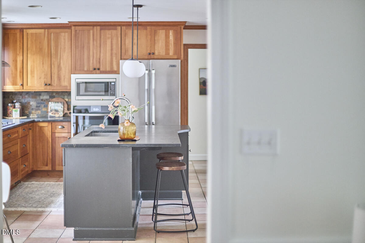 8109 Olde Hill Court Raleigh, NC 27615 - Photo 22 of 65 a kitchen with stainless steel appliances a refrigerator and a stove