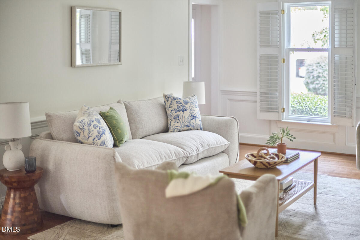 8109 Olde Hill Court Raleigh, NC 27615 - Photo 26 of 65 a living room with a couch and a potted plant