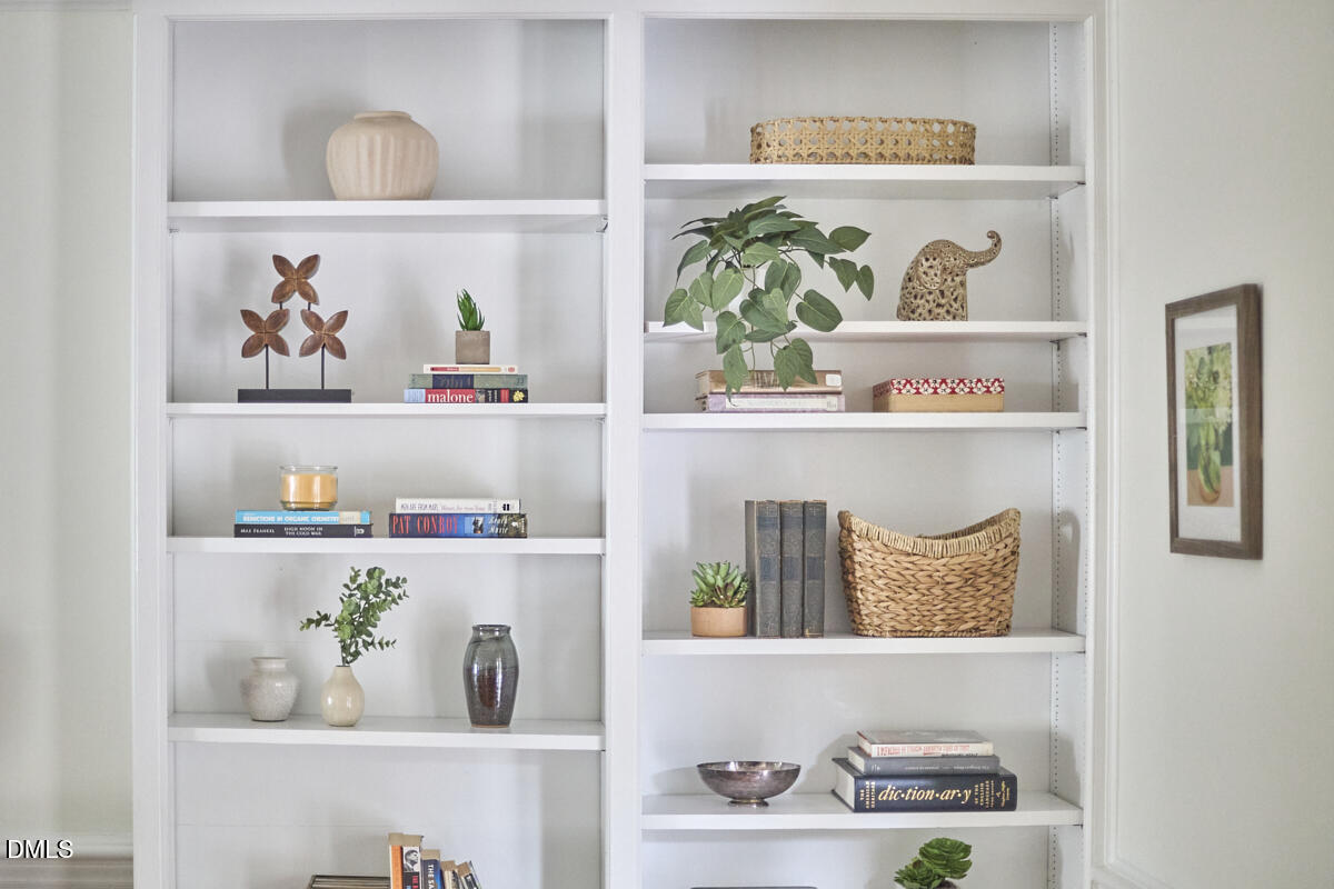 8109 Olde Hill Court Raleigh, NC 27615 - Photo 30 of 65 a shelf with books and knick knacks on it