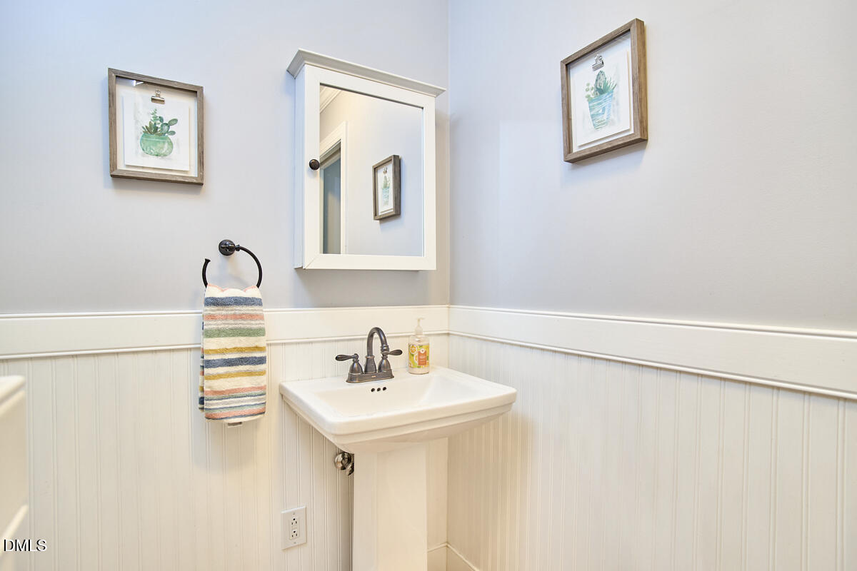 8109 Olde Hill Court Raleigh, NC 27615 - Photo 34 of 65 a bathroom with a sink and a mirror