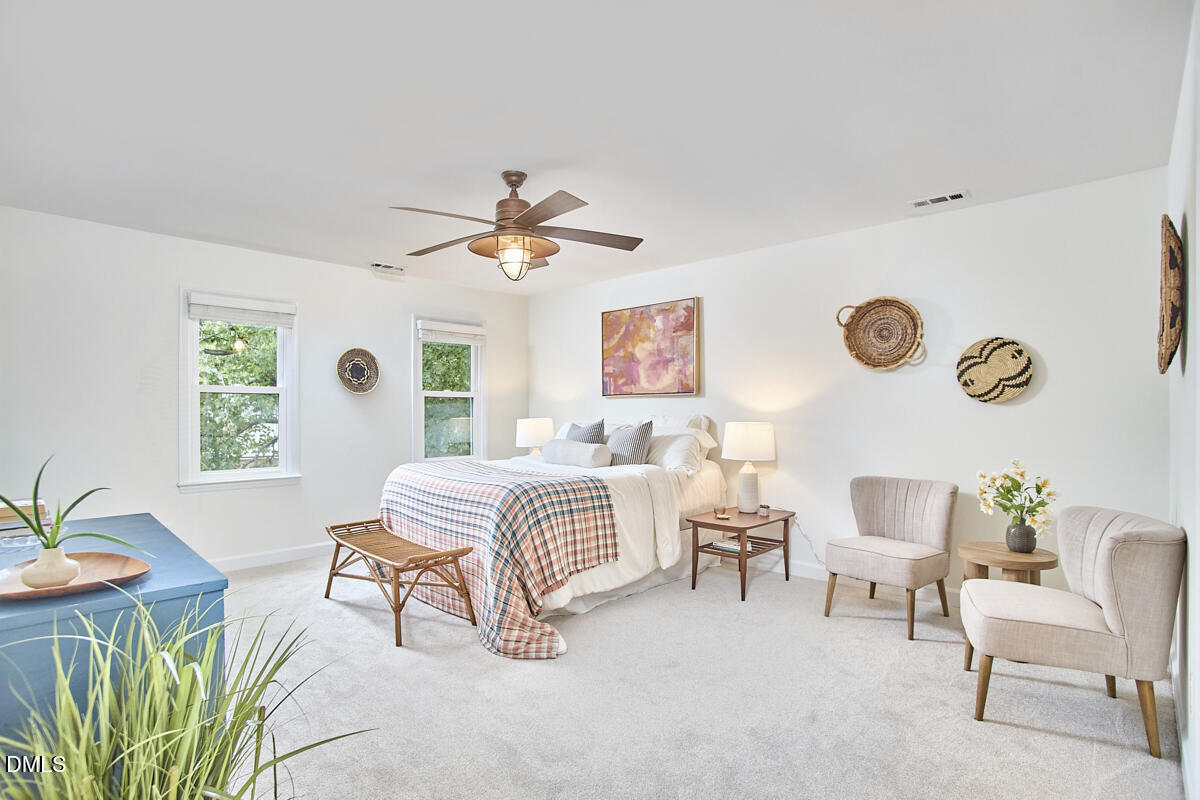 8109 Olde Hill Court Raleigh, NC 27615 - Photo 35 of 65 a bedroom with a bed and a chandelier