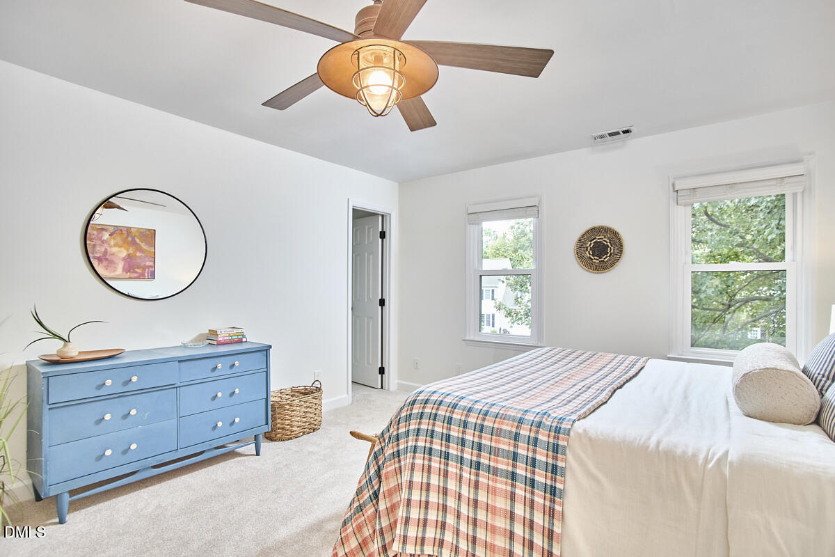 8109 Olde Hill Court Raleigh, NC 27615 - Photo 36 of 65 a bedroom with a bed and a chandelier