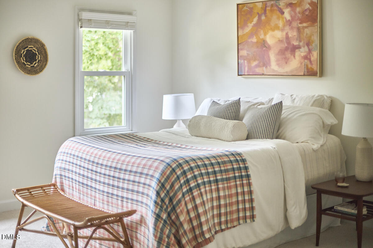 8109 Olde Hill Court Raleigh, NC 27615 - Photo 37 of 65 a bedroom with a bed and chair