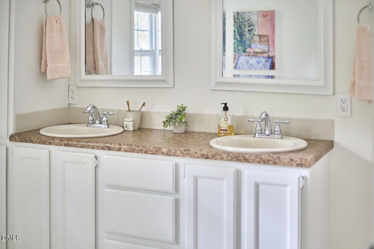 8109 Olde Hill Court Raleigh, NC 27615 - Photo 43 of 65 a bathroom with sinks granite and a sink