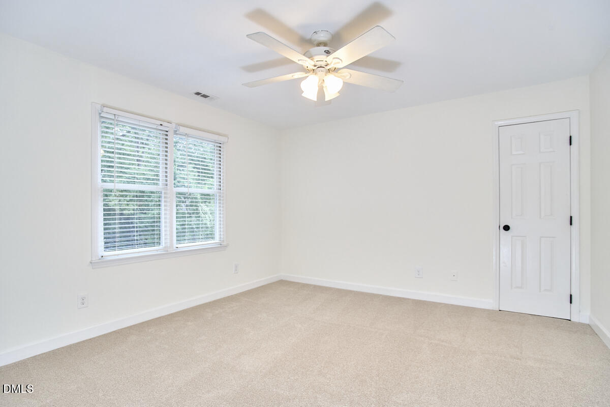 8109 Olde Hill Court Raleigh, NC 27615 - Photo 47 of 65 an empty room with a window and a fan
