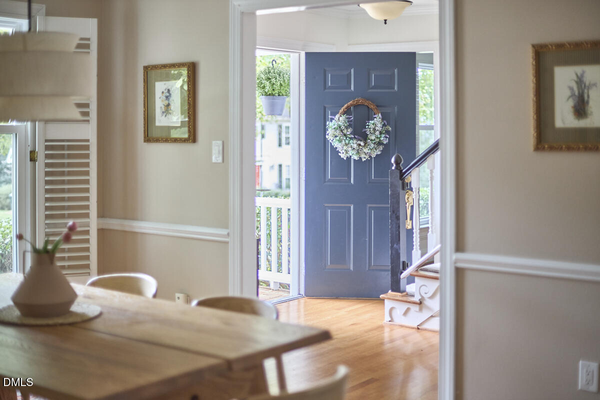 8109 Olde Hill Court Raleigh, NC 27615 - Photo 6 of 65 a living room with furniture a chandelier and a window