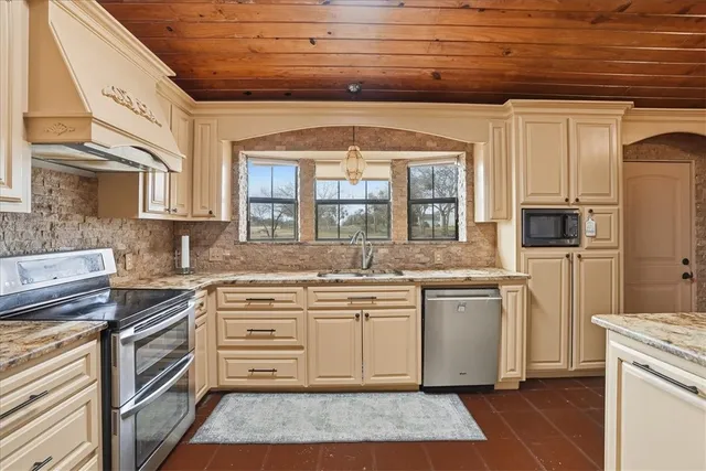 a bed sitting in a spacious bedroom next to a window