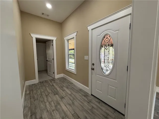 a view of a hallway to a livingroom with furniture