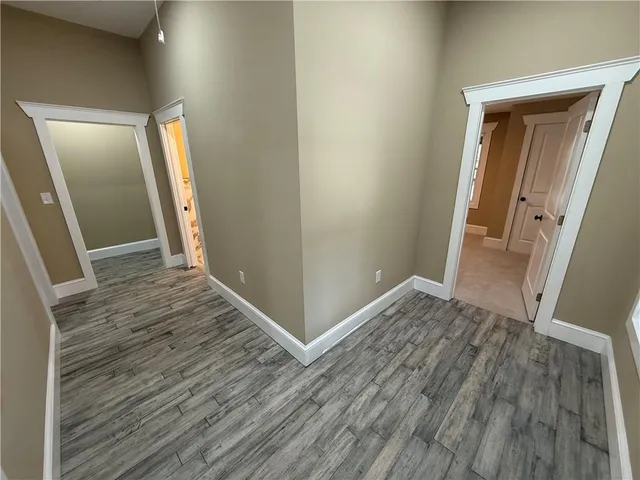 a view of hallway with wooden floor