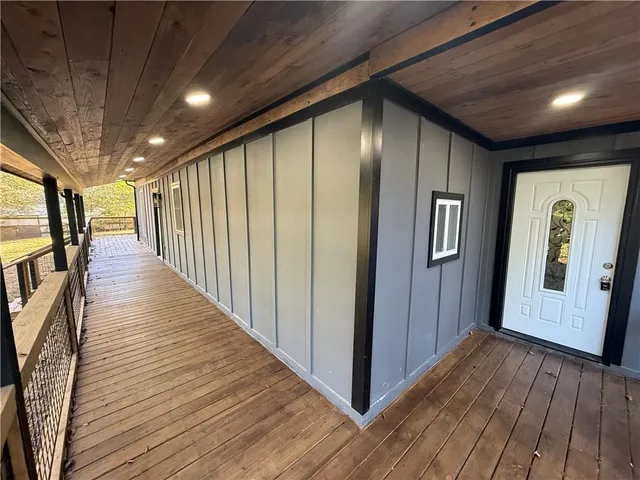 a view of a hallway with wooden floor