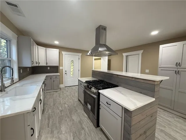 a kitchen with a stove a sink and a refrigerator