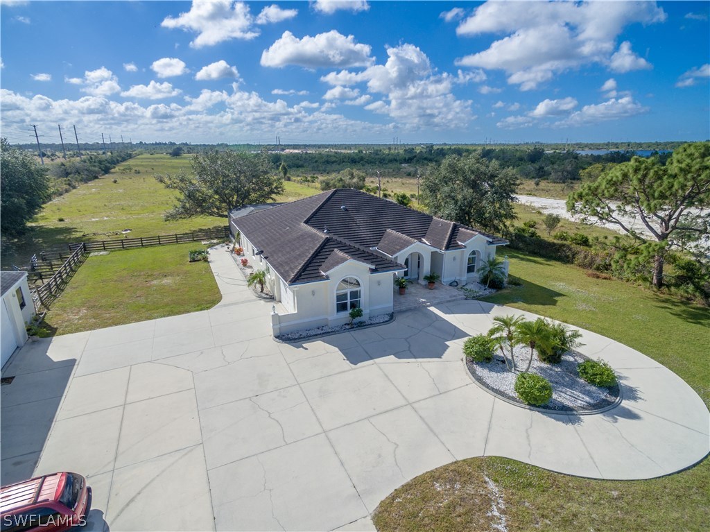 38830 Washington Loop Road Punta Gorda, FL 33982 - Photo 1 of 25 an aerial view of a house with a garden