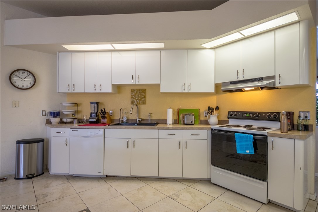 38830 Washington Loop Road Punta Gorda, FL 33982 - Photo 12 of 25 a kitchen with granite countertop cabinets stainless steel appliances and a sink