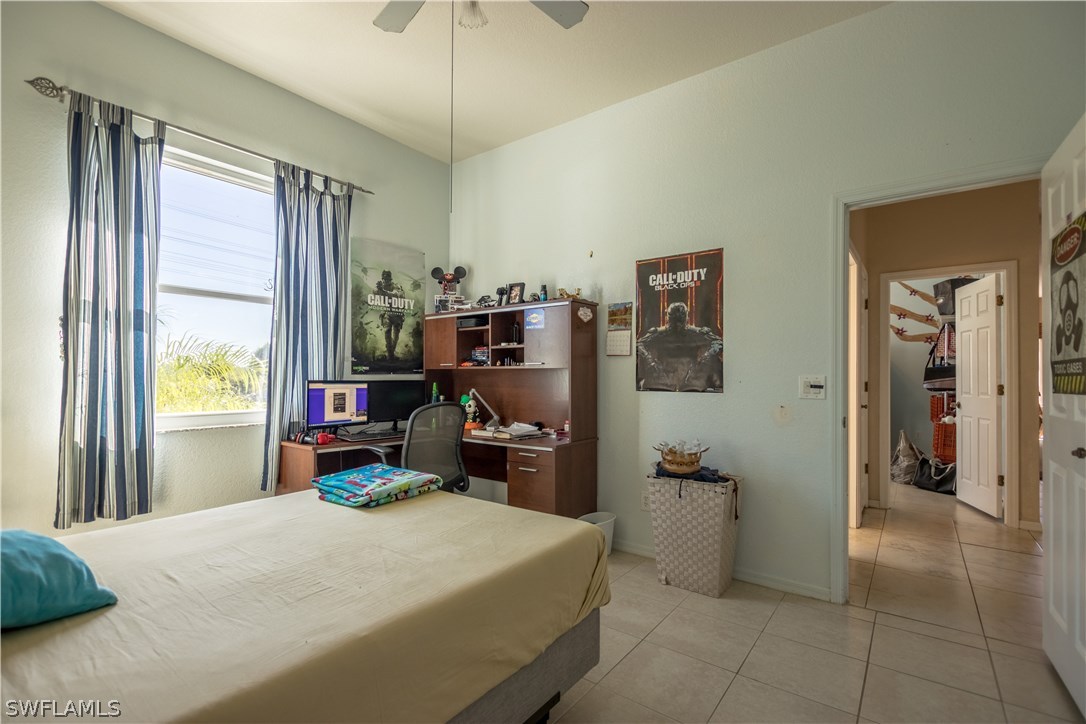 38830 Washington Loop Road Punta Gorda, FL 33982 - Photo 17 of 25 a bedroom with a bed and a chandelier