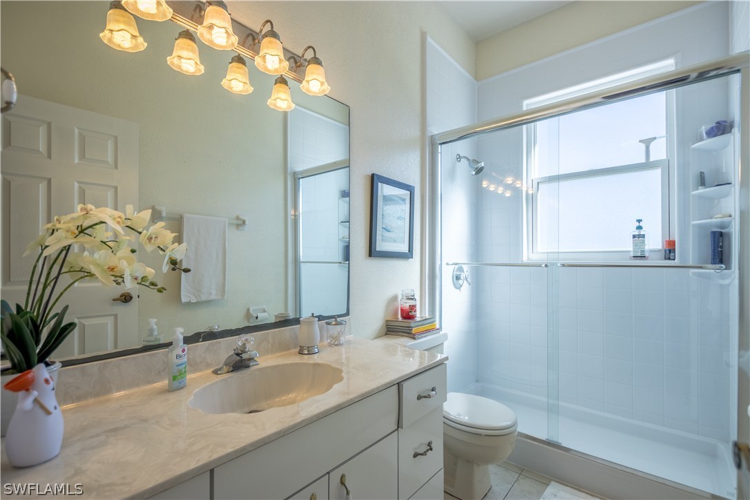 38830 Washington Loop Road Punta Gorda, FL 33982 - Photo 18 of 25 a bathroom with a sink a toilet and a mirror