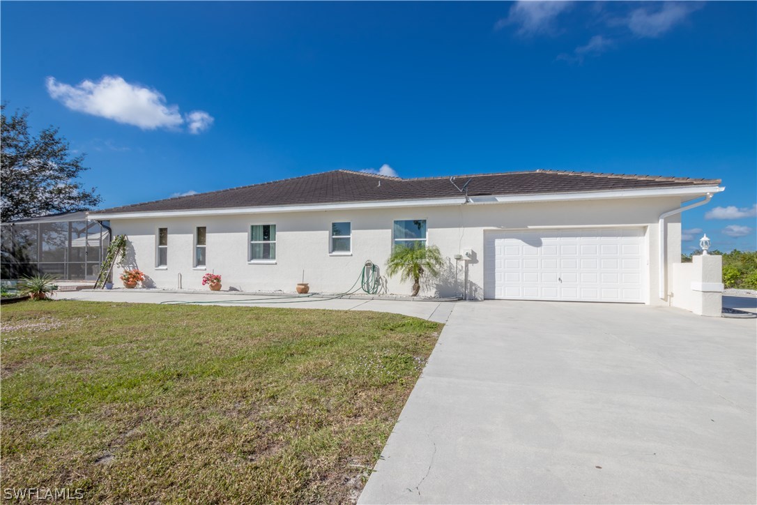 38830 Washington Loop Road Punta Gorda, FL 33982 - Photo 24 of 25 a front view of a house with garden