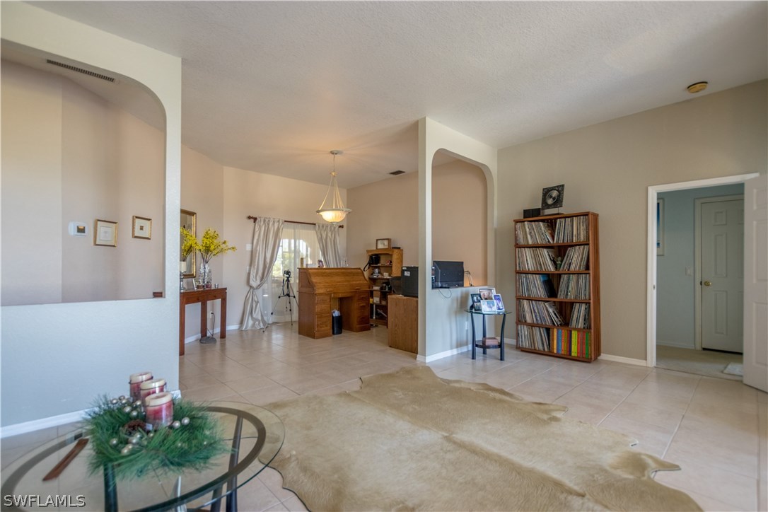 38830 Washington Loop Road Punta Gorda, FL 33982 - Photo 7 of 25 a living room with furniture and a dining table with bookshelf