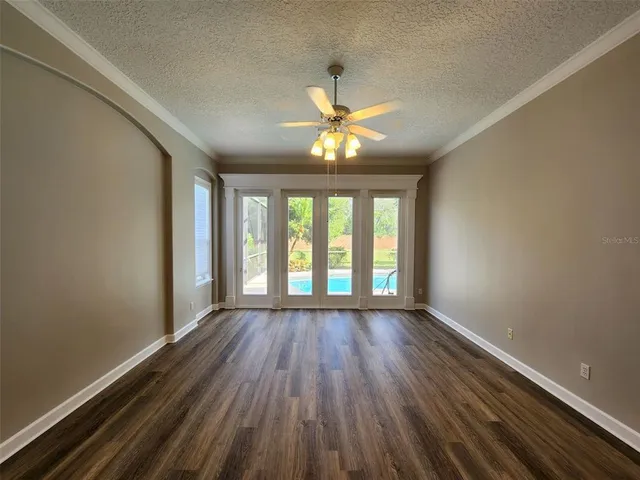 a view of room with window ceiling fan and hardwood floor