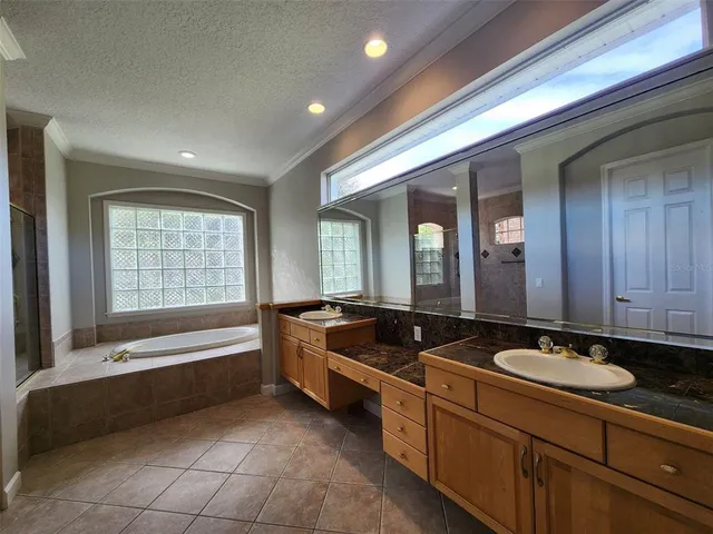 a spacious bathroom with a granite countertop tub and a sink