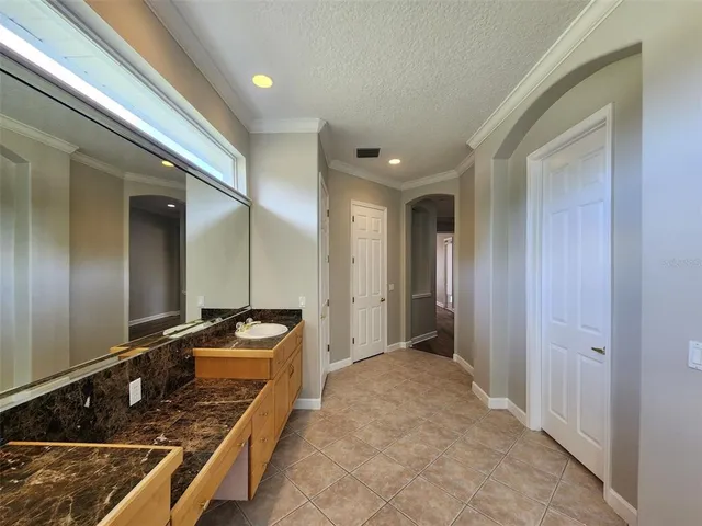 a kitchen with sink stove and refrigerator