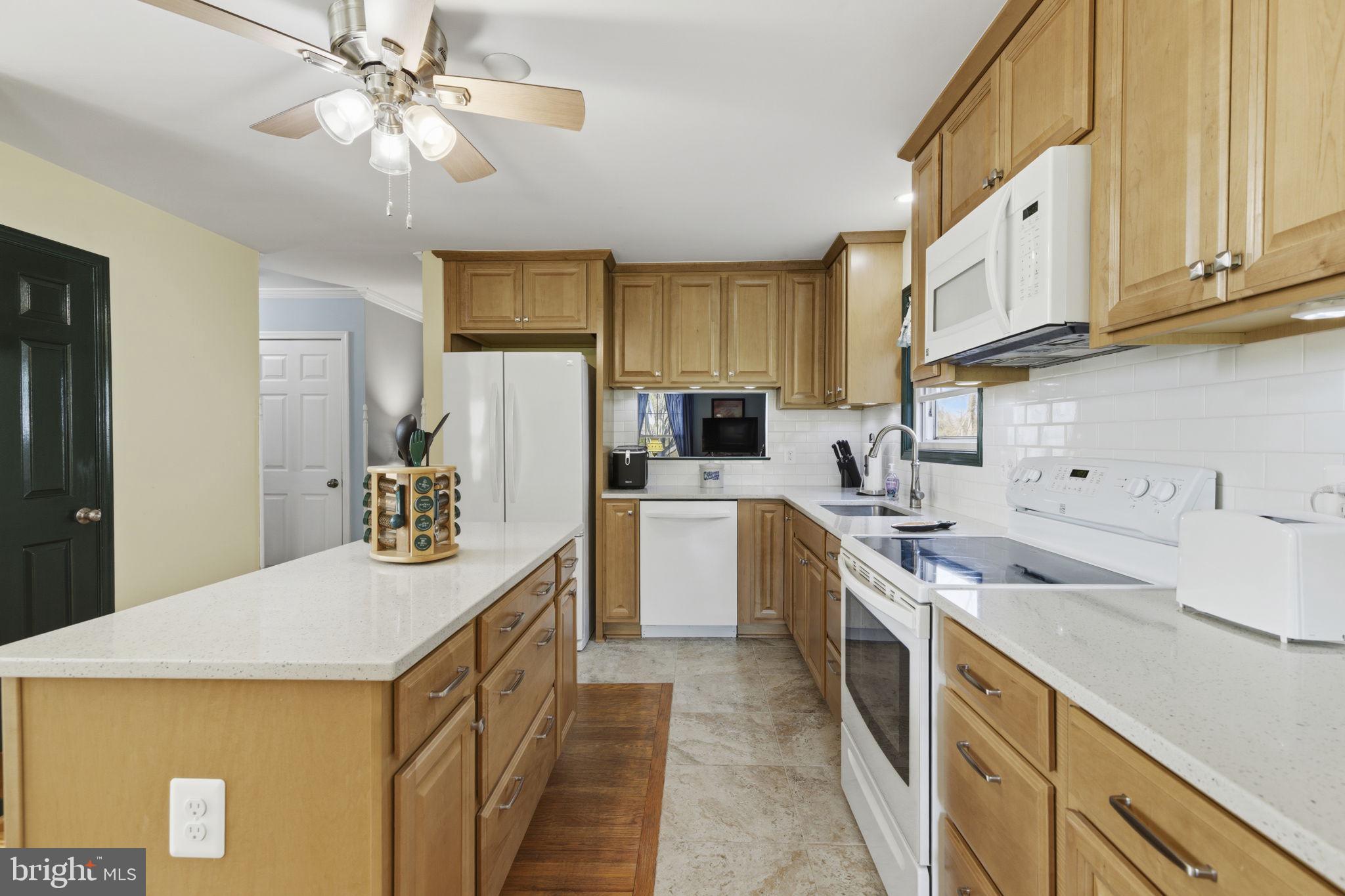 3831 Wilkinson Road Havre de Grace, MD 21078 - Photo 7 of 51 a kitchen with a sink a stove and cabinets