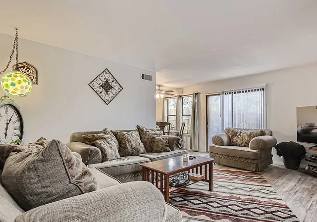 a living room with furniture and a large window