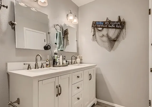 a bathroom with a double vanity sink and a mirror