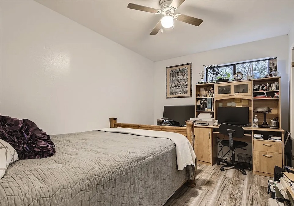 9026 Sawtooth Lane, Unit A Austin, TX 78729 - Photo 7 of 10 a bedroom with a bed and a flat screen tv