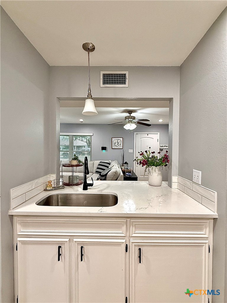213 Sparrow Lane Victoria, TX 77905 - Photo 20 of 44 a view of kitchen sink a counter space and cabinets