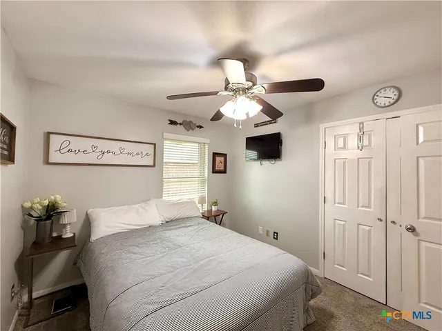 a bedroom with a bed and a tv