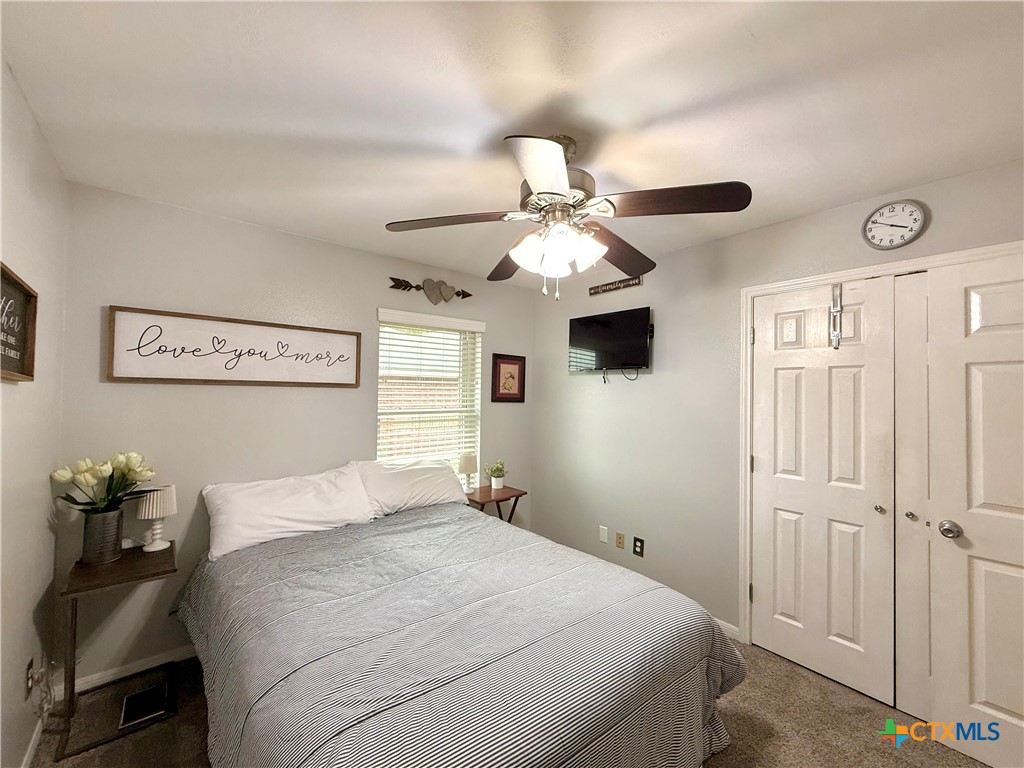 213 Sparrow Lane Victoria, TX 77905 - Photo 30 of 44 a bedroom with a bed and a chandelier