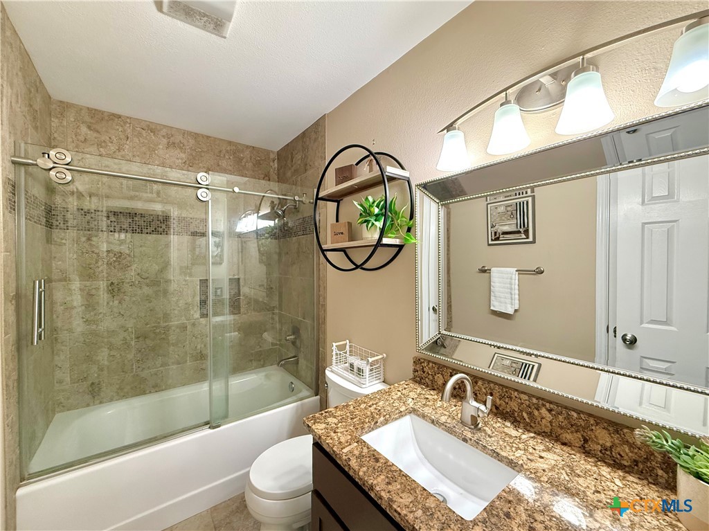 213 Sparrow Lane Victoria, TX 77905 - Photo 34 of 44 a bathroom with a granite countertop sink toilet and shower