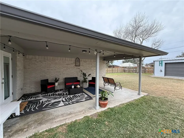 a backyard of a house with table and chairs