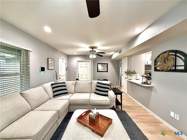 a living room with furniture and wooden floor