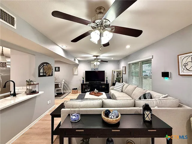 a living room with furniture a window and a chandelier