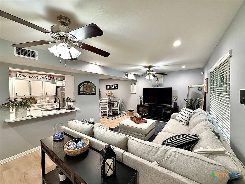 213 Sparrow Lane Victoria, TX 77905 - Photo 10 of 44 a living room with furniture and a flat screen tv
