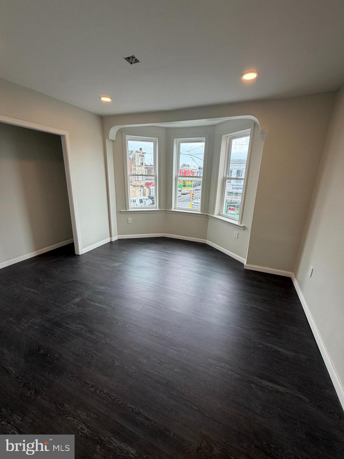 3760 North 9th Street Philadelphia, PA 19140 - Photo 9 of 17 an empty room with wooden floor and windows